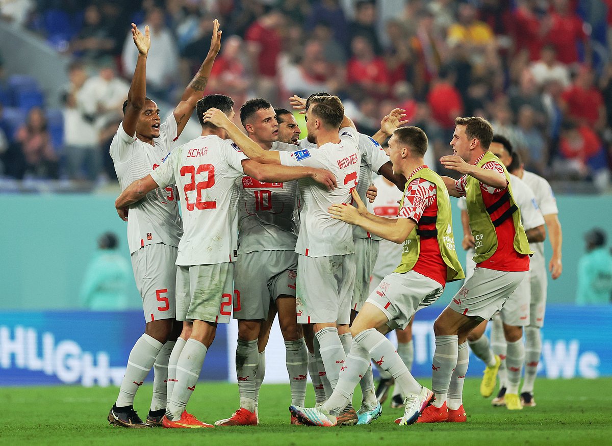 Switzerland players celebrate qualifying for the knockout stages