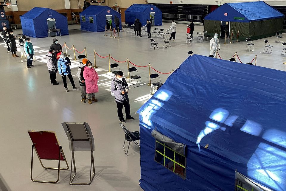 People line up at a makeshift fever clinic set up inside a stadium, amid the coronavirus disease (Covid-19) outbreak in Beijing, China on 19 December, 2022.