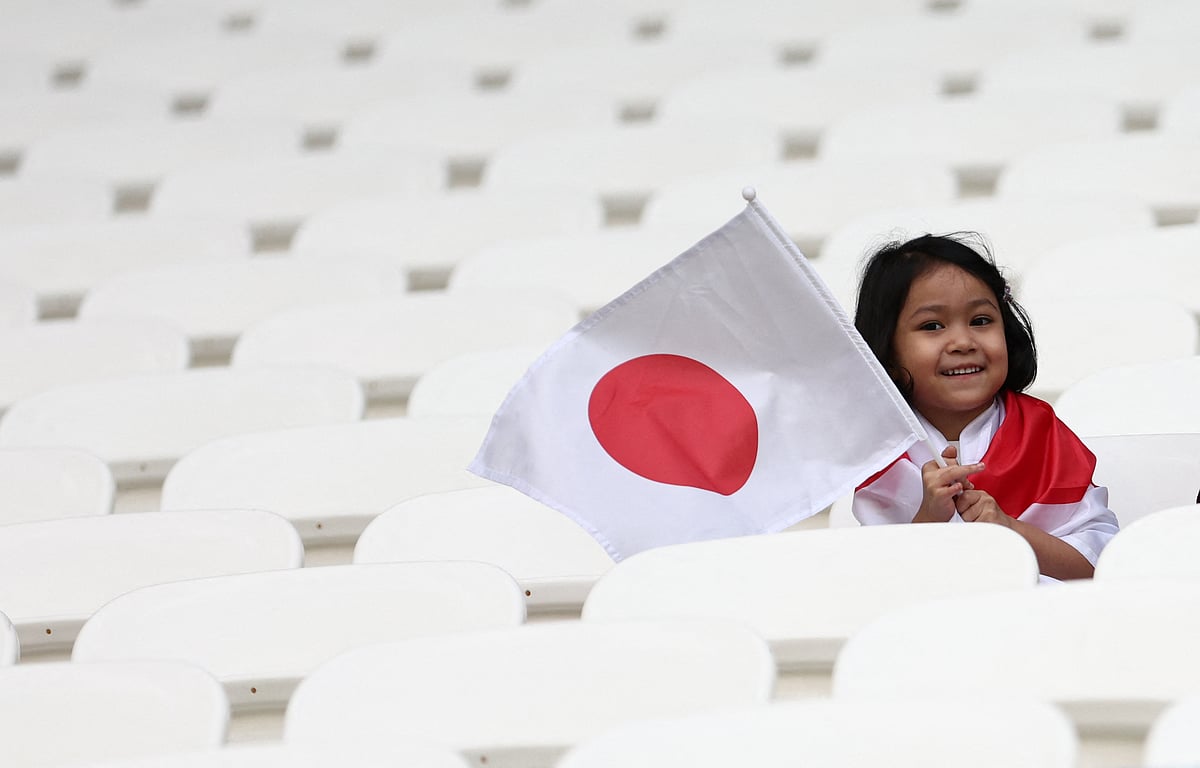 A fan holds a Japan flag inside the stadium before the FIFA World Cup 2022 Round of 16 match of Japan v Croatia at the Al Janoub Stadium in Al Wakrah, Qatar on 5 December, 2022