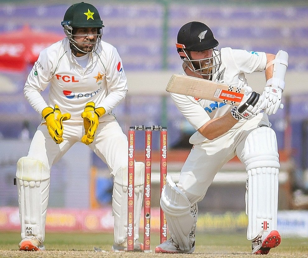 Kane Williamson plays a shot as Sarfaraz Ahmed looks on day three of the Pakistan v  New Zealand Test at the National Stadium in Karachi, Pakistan on 28 December, 2022