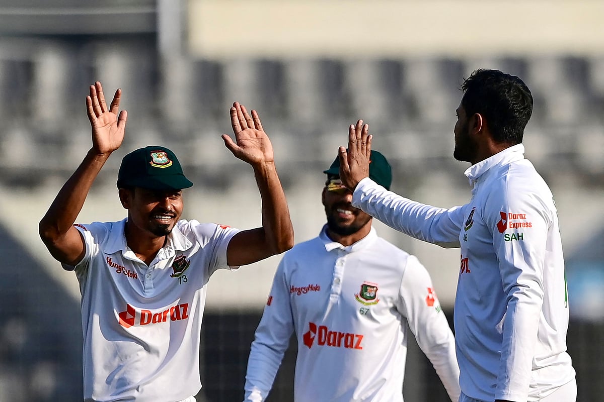 Bangladesh's Shakib Al Hasan celebrates with teammates after the dismissal of India's Axar Patel during the second day of the second Test between Bangladesh and India at the Sher-e-Bangla National Cricket Stadium in Dhaka on 23 December, 2022