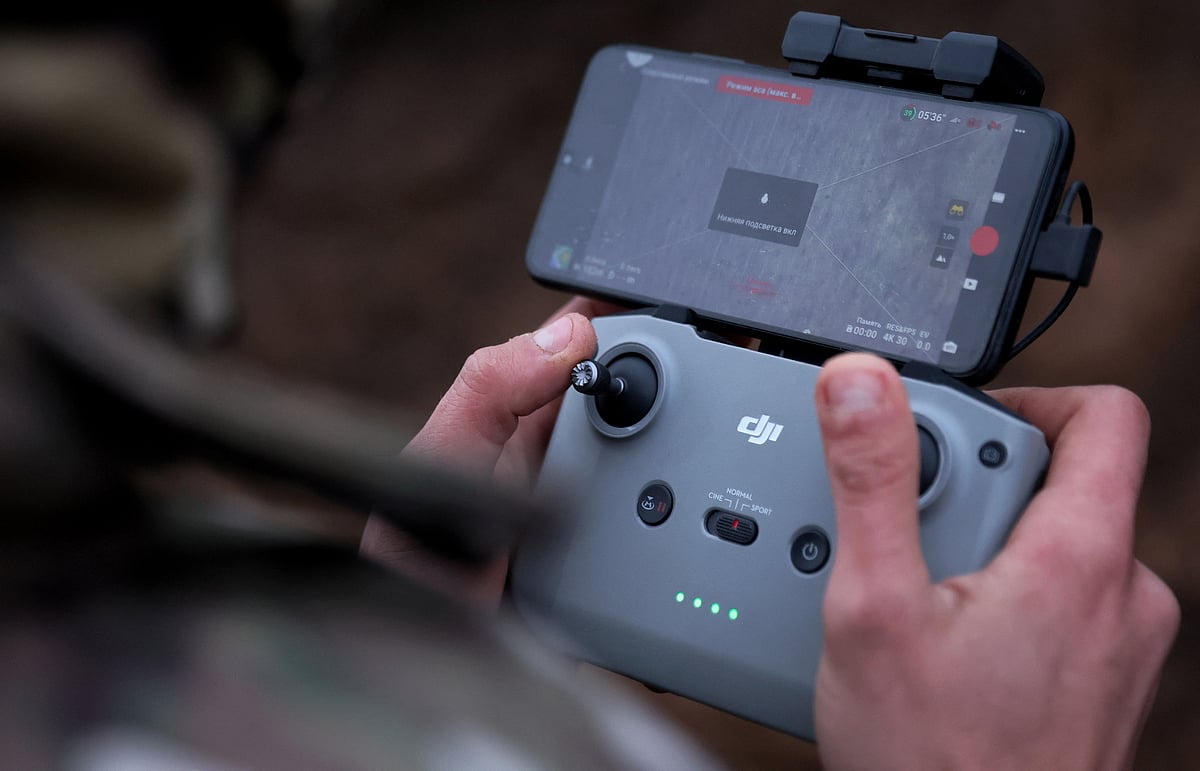 A soldier with the 58th Independent Motorized Infantry Brigade of the Ukrainian Army, releases a modified grenade from a drone during a test flight as Russia's invasion of Ukraine continues, near Bakhmut, Ukraine