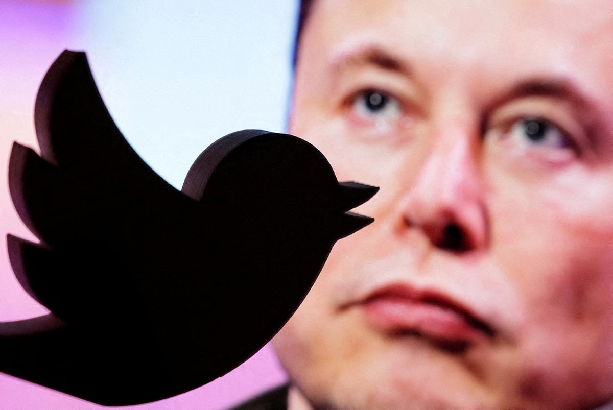 A 3D printed Twitter logo is seen in front of a displayed photo of Elon Musk in this illustration taken 27 October, 2022.