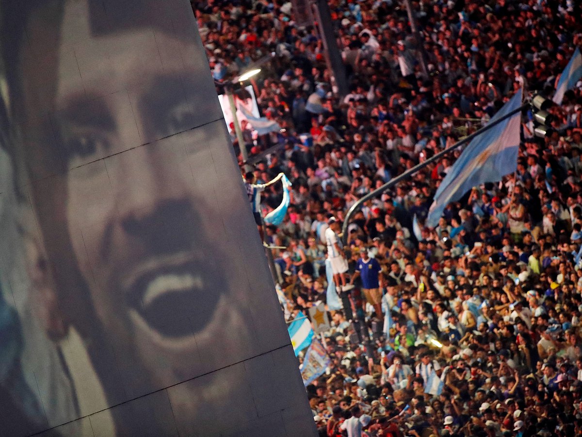 Argentina fans celebrate winning the World Cup at the Obelisk with an image of Lionel Messi in Buenos Aires, Argentina on 18 December, 2022