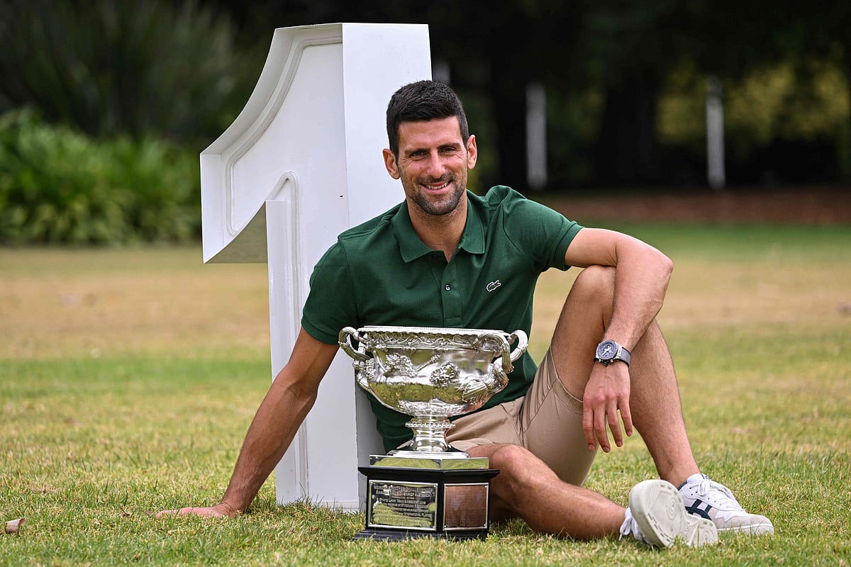 Serbia's Novak Djokovic celebrates with the Norman Brookes Challenge Cup trophy a day after his victory against Greece's Stefanos Tsitsipas in the men's singles final of the Australian Open in Melbourne on 30 January, 2023