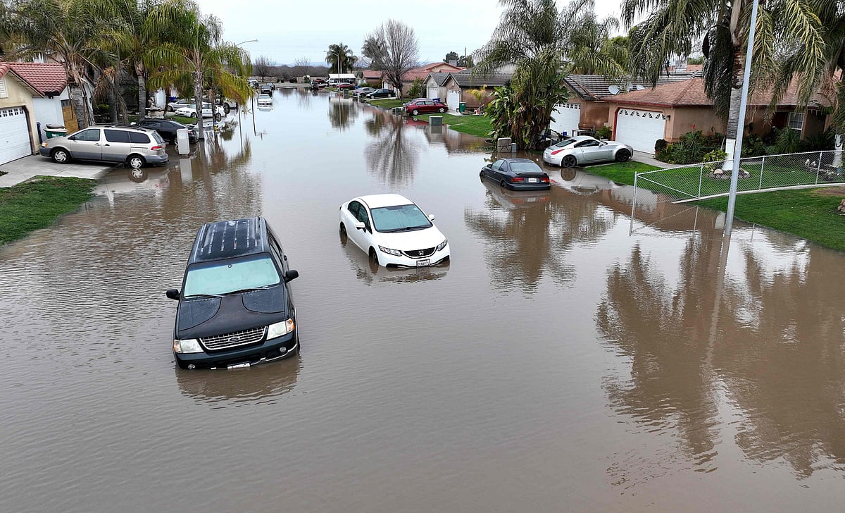 In an aerial view, cars sit in floodwaters on 11 January, 2023 in Planada, California.