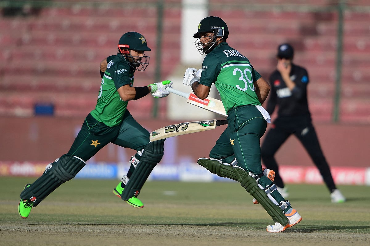 Pakistan's Fakhar Zaman (R) and teammate Mohammad Rizwan run between the wickets during the third and final one-day international (ODI) cricket match between Pakistan and New Zealand at the National Stadium in Karachi on January 13, 2023