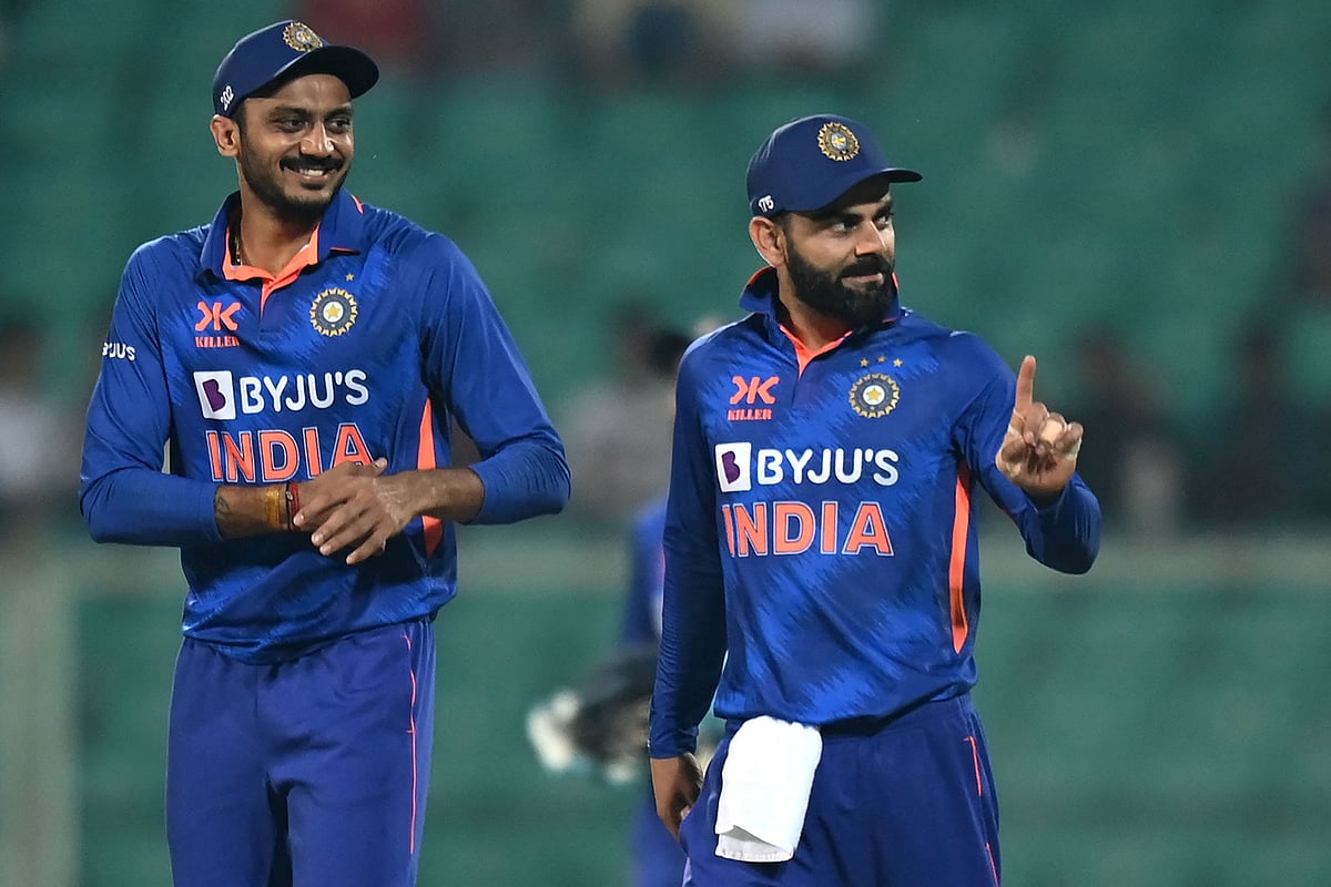 India's Virat Kohli gestures as Axar Patel watches during the third and final ODI between India and Sri Lanka at the Greenfield International Stadium in Thiruvananthapuram on 15 January, 2023