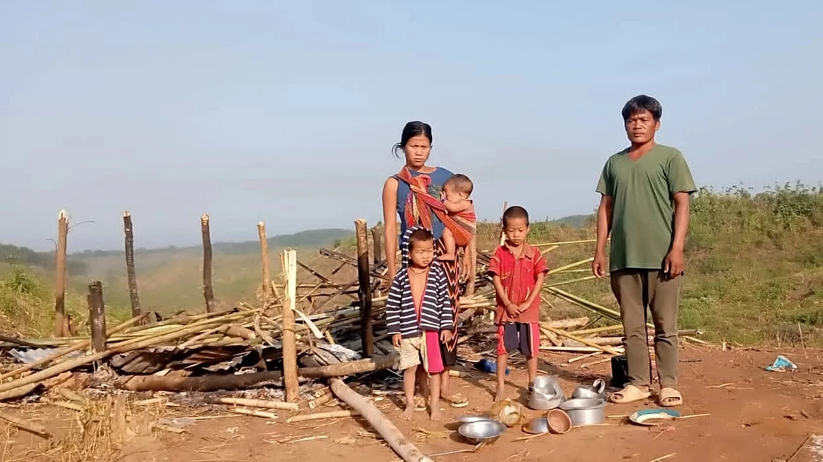 A family stands in front of their damaged house in Rengyenpara in Bandarban’s Lama upazila on 2 January 2023.