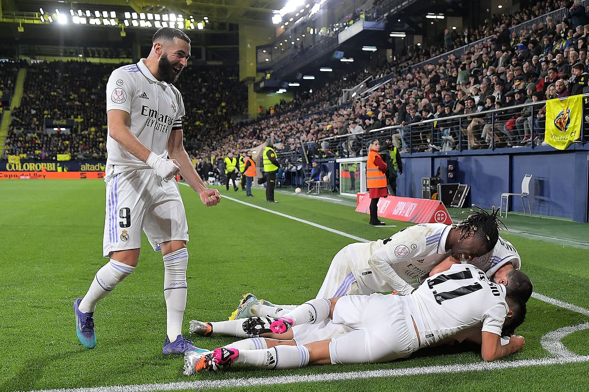 Real Madrid's Spanish midfielder Dani Ceballos (Down) celebrates with teammates after scoring his team's third goal during the Spain's Copa del Rey (King's Cup), round of 16 football match between Villarreal CF and Real Madrid CF at La Ceramica stadium in Vila-Real, near Valencia, on January 19, 2023