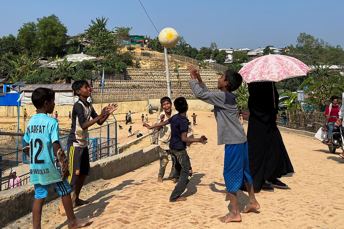 Rohingya children play with a football inside a refugee camp in Cox’s Bazar, Bangladesh, on 30 December, 2022