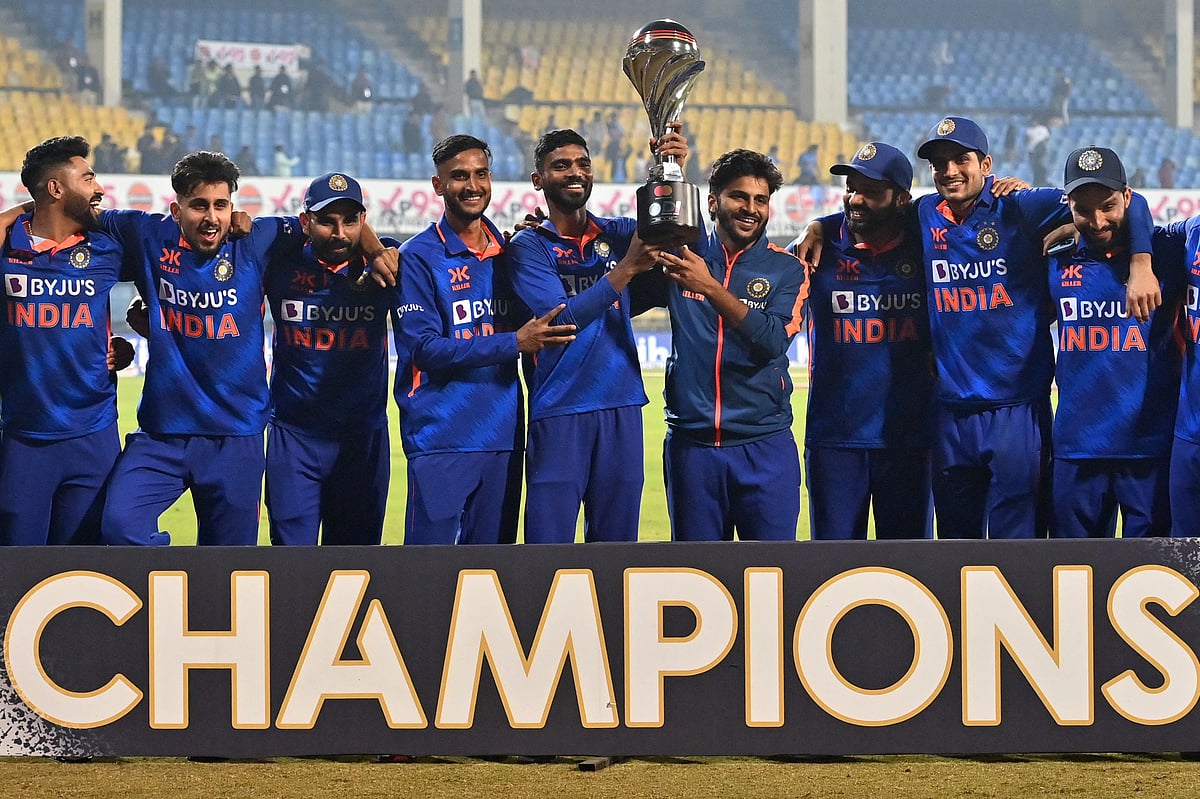 India's players pose with the trophy after winning the third and final ODI between India and New Zealand at the Holkar Cricket Stadium in Indore on 24 January, 2023