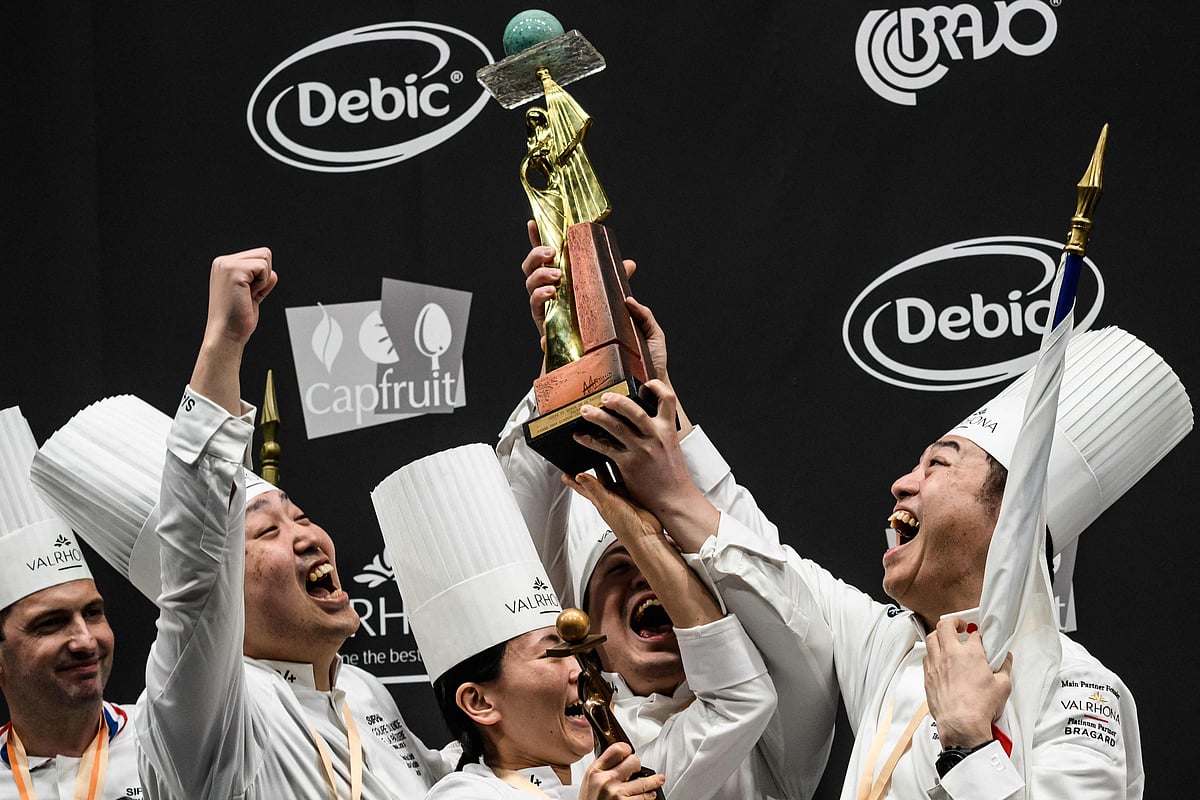 Members of team Japan hold the trophy as they celebrate winning the 2023 Bocuse d’Or pastry competition at the SIRHA (Salon International de la Restauration, de l’Hôtellerie et de l’Alimentation) in Chassieu Eurexpo hall near Lyon, southeastern France, on 21 January, 2023.