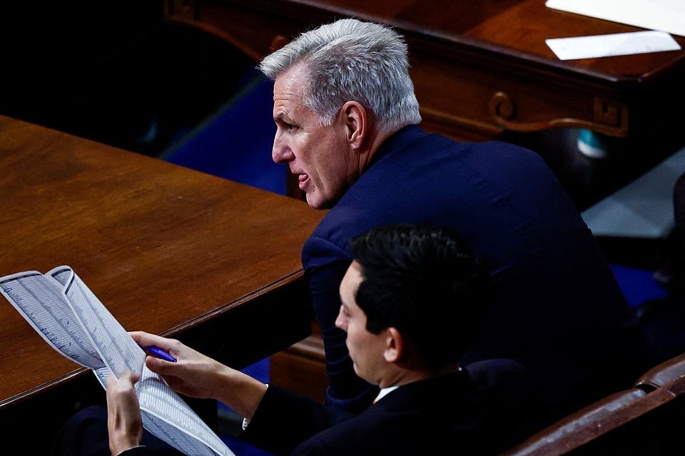 Republican Leader Kevin McCarthy (R-CA) is flanked by an aide as he listens during a 12th round of voting for a new Speaker on the fourth day of the 118th Congress at the US Capitol in Washington, US, on 6 January, 2023.
