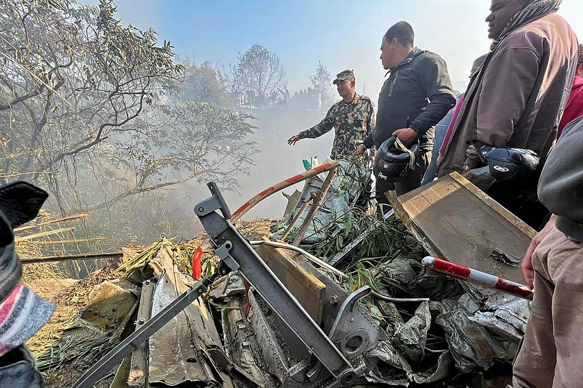 Rescuers gather at the site of a plane crash in Pokhara on 15 January, 2023. An aircraft with 72 people on board crashed in Nepal on January 15, Yeti Airlines and a local official said