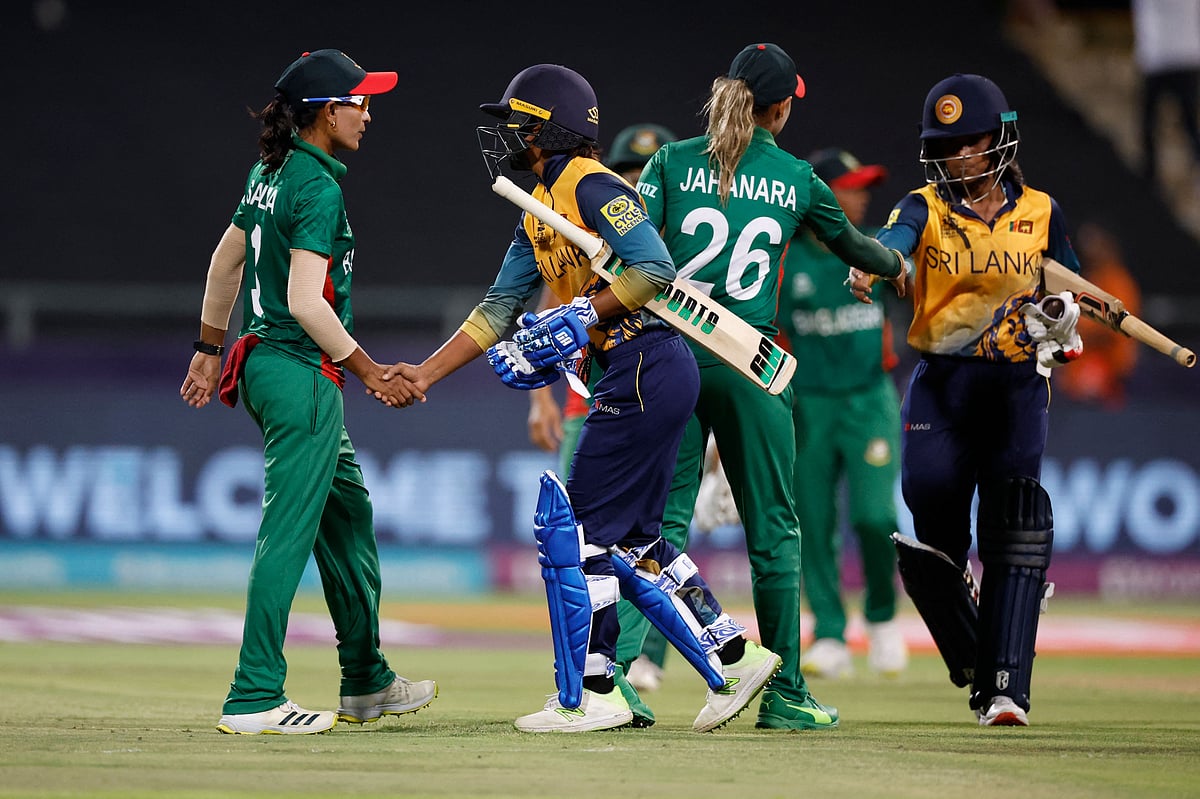 Sri Lanka's Nilakshi De Silva and Sri Lanka's Harshitha Samarawickrama shake hands with Bangladesh's Jahanara Alam and Salma Khatun after Sri Lanka won the Group A ICC T20 women's World Cup match between Bangladesh and Sri Lanka at Newlands Stadium in Cape Town on 12 February, 2023