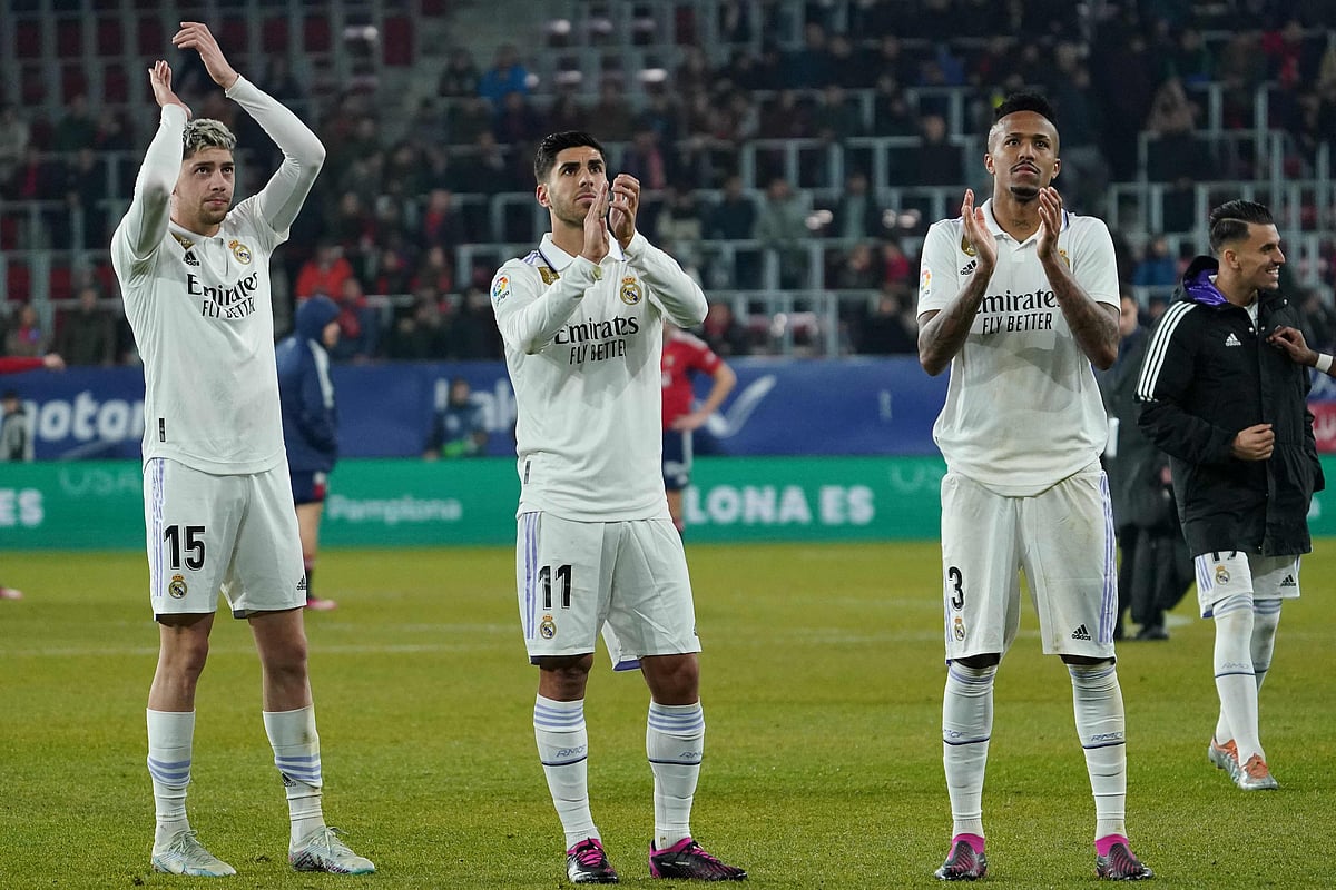Real Madrid's Uruguayan midfielder Federico Valverde, Spanish midfielder Marco Asensio and Brazilian defender Eder Militao clap at the end of the La Liga match between CA Osasuna and Real Madrid CF at El Sadar stadium in Pamplona on 18 February, 2023