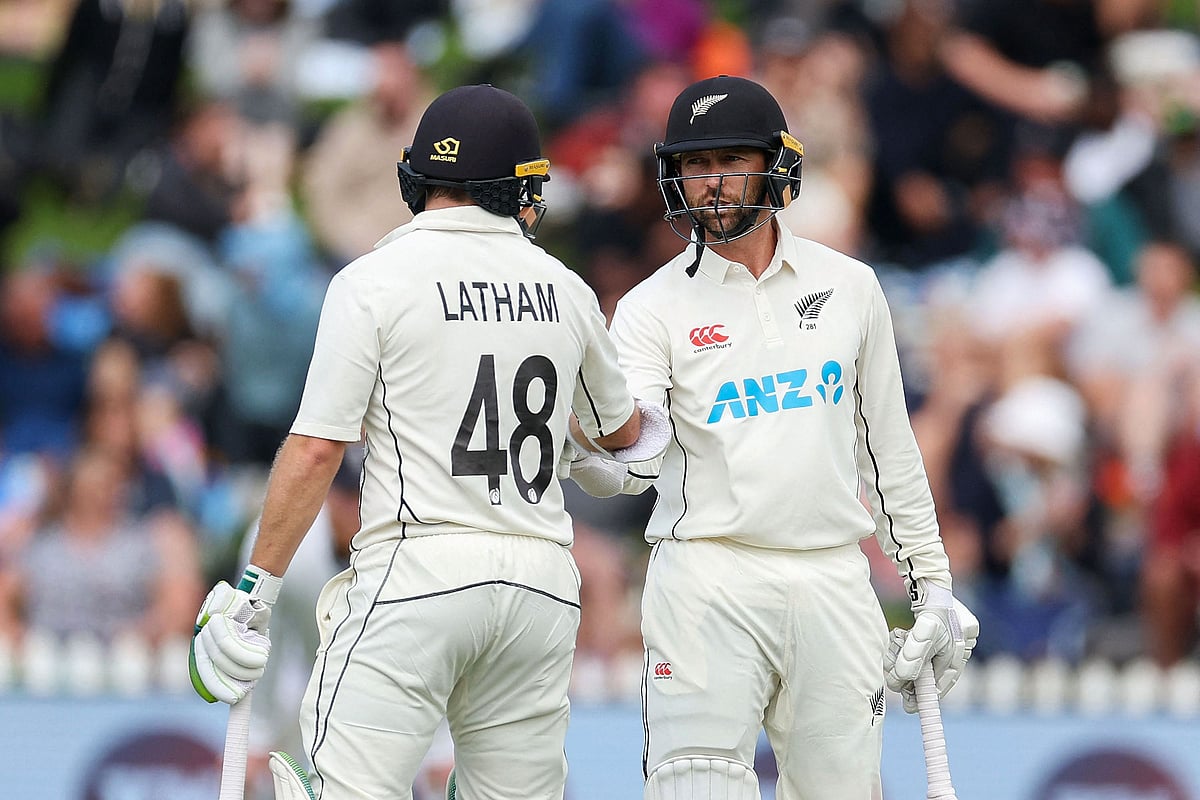 New Zealand's Devon Conway celebrates 50 runs with teammate Tom Latham during day three of the second cricket Test match between New Zealand and England at the Basin Reserve in Wellington on 26 February, 2023