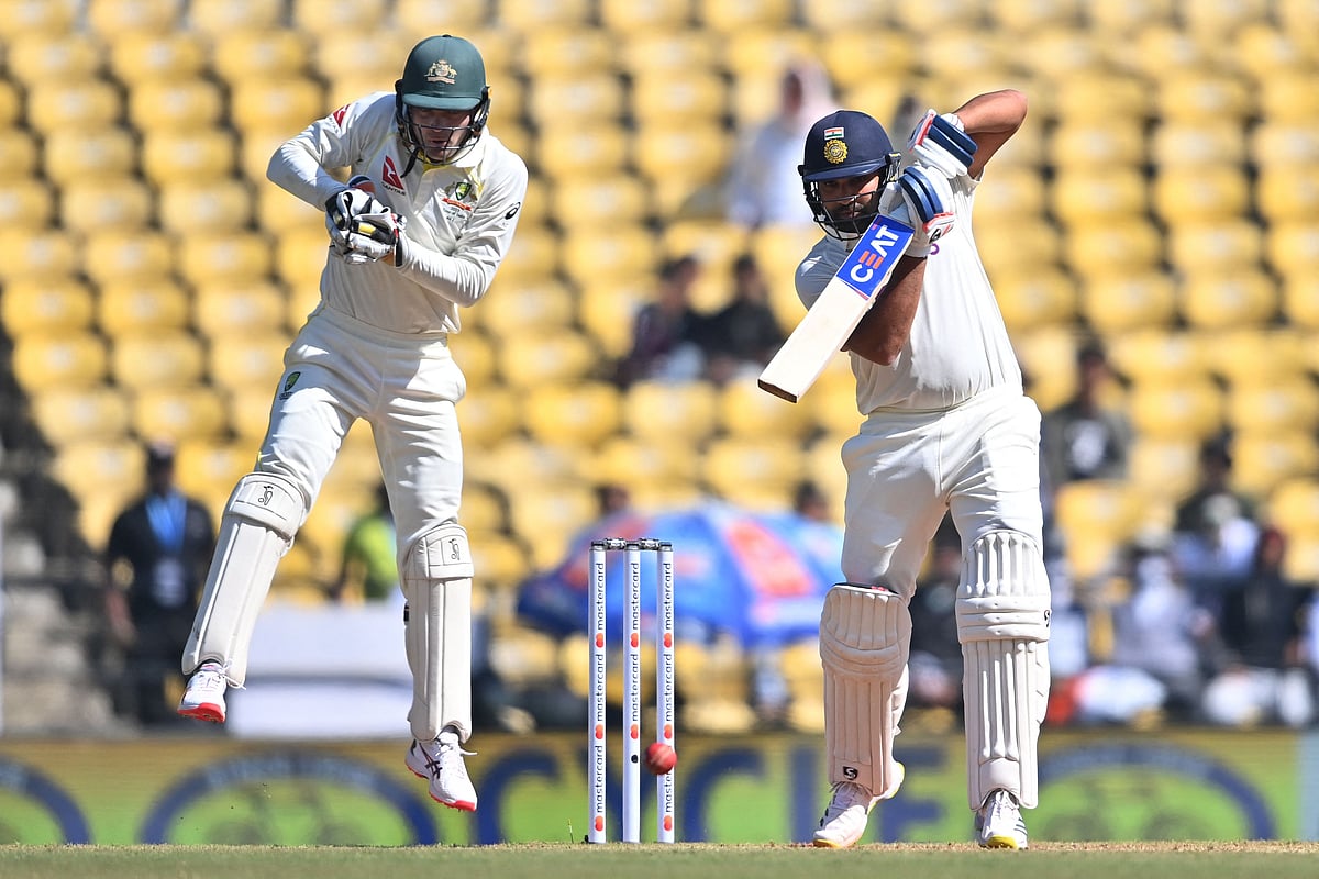 India's captain Rohit Sharma plays a shot as Australia's Alex Carey jumps during the second day of the first Test between India and Australia at the Vidarbha Cricket Association (VCA) Stadium in Nagpur on 10 February, 2023