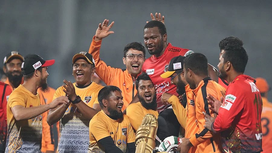 Comilla Victorians support staff celebrate with Johnson Charles after a record-setting win over Khulna Tigers in their BPL9 match at the Sylhet International Cricket Stadium on 1 February, 2023