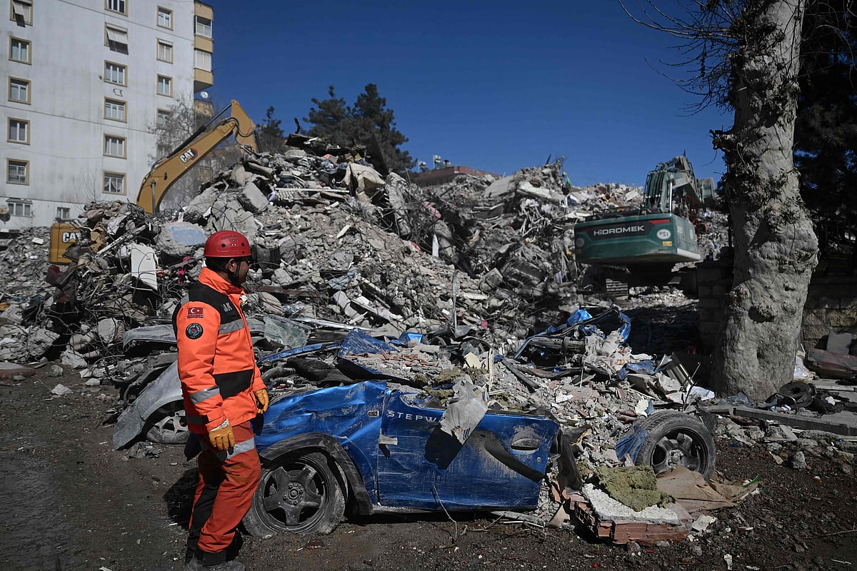 A rescuer stands in front of rubble near the site where Aleyna Olmez, 17, was rescued from a collapsed building, 248 hours after the 7.8-magnitude earthquake which struck parts of Turkey and Syria, in Kahramanmaras on 16 February, 2023.