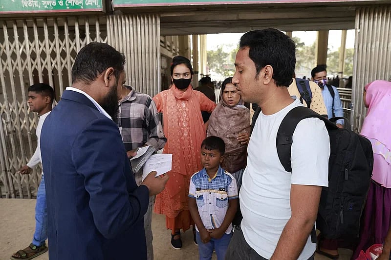 A ticket checker checks ticket of a passenger with POS at Kamalapur Railway Station, Dhaka, on 1 March 2023