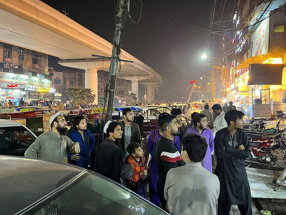 People come out of a restaurant after a tremor was felt in Lahore, Pakistan on 21 March, 2023.