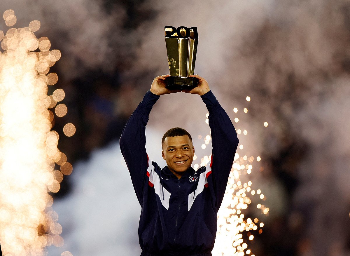 Paris Saint-Germain's Kylian Mbappe celebrates with a trophy during the ceremony after becoming PSG's all time top goal scorer with 201 goals after their Ligue 1 match against Nantes at the Parc des Princes in Paris, France on 4 March 2023