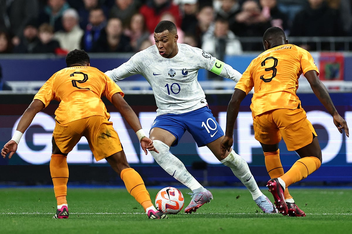 France's forward Kylian Mbappe fights for the ball with Netherlands' midfielder Jurrien Timber and defender Lutsharel Geertruida during the UEFA Euro 2024 qualification match between France and Netherlands at the Stade de France in Saint-Denis, north of Paris on 24 March 2023