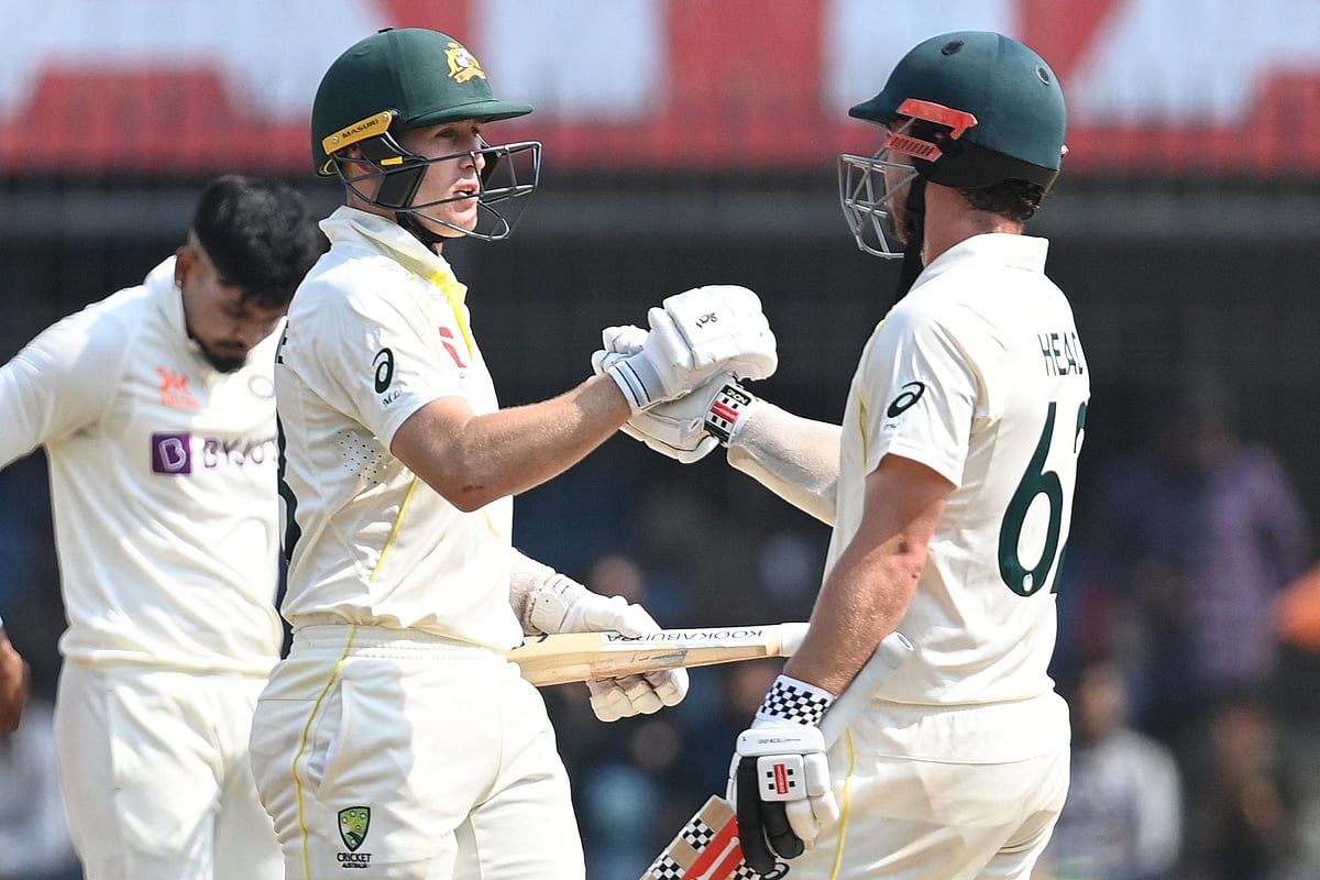 Australia's Marnus Labuschagne (L) shakes hands with Australia's Travis Head (R) after Australia's victory during the third day of the third Test between India and Australia at the Holkar Stadium in Indore on 3 March 2023