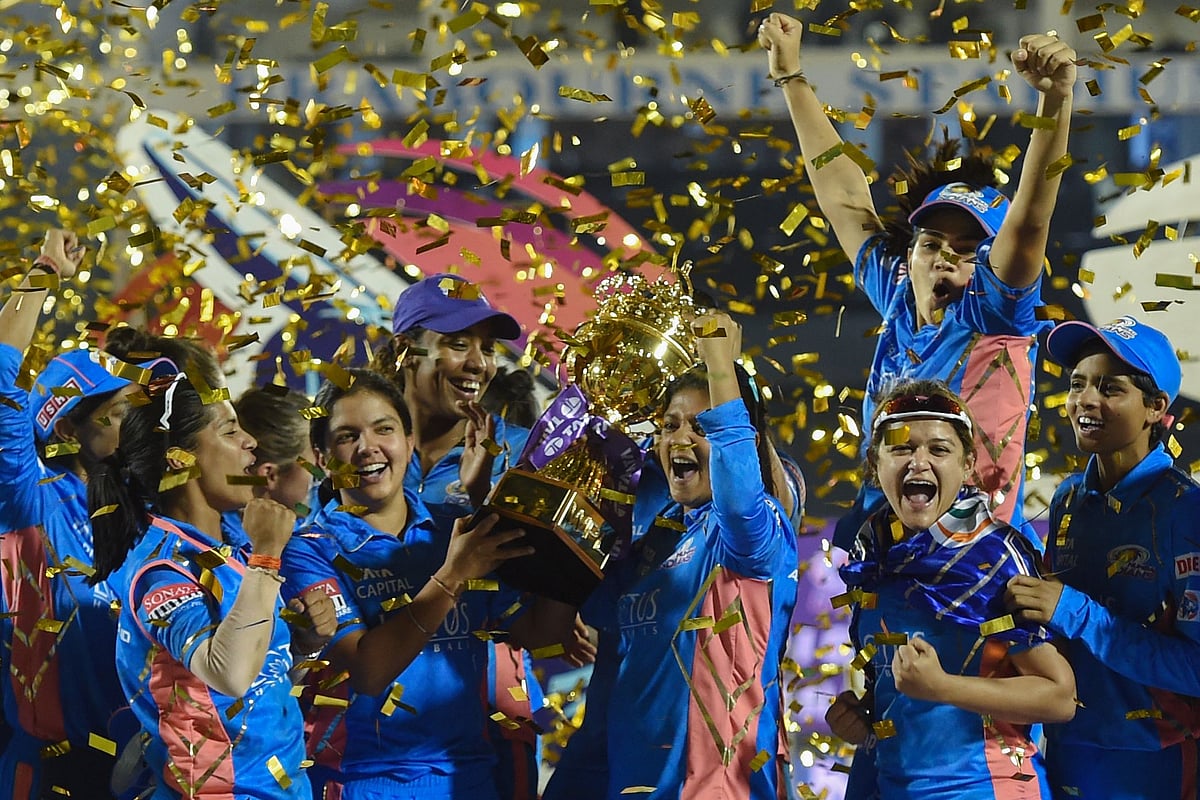 Mumbai Indians' players pose with the trophy after winning the 2023 Women's Premier League (WPL) final between Delhi Capitals and Mumbai Indians at the Brabourne Stadium in Mumbai on 26 March 2023