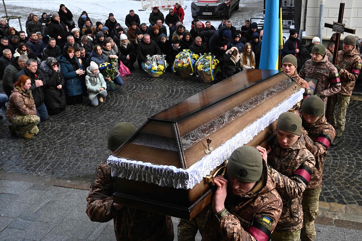 Ukrainian soldiers carry a coffin of their comrade Vasyl Chepak, Ukrainian serviceman killed in combat, during the funeral service at the Saints Peter and Paul Garrison Church in Lviv on 28 February, 2023