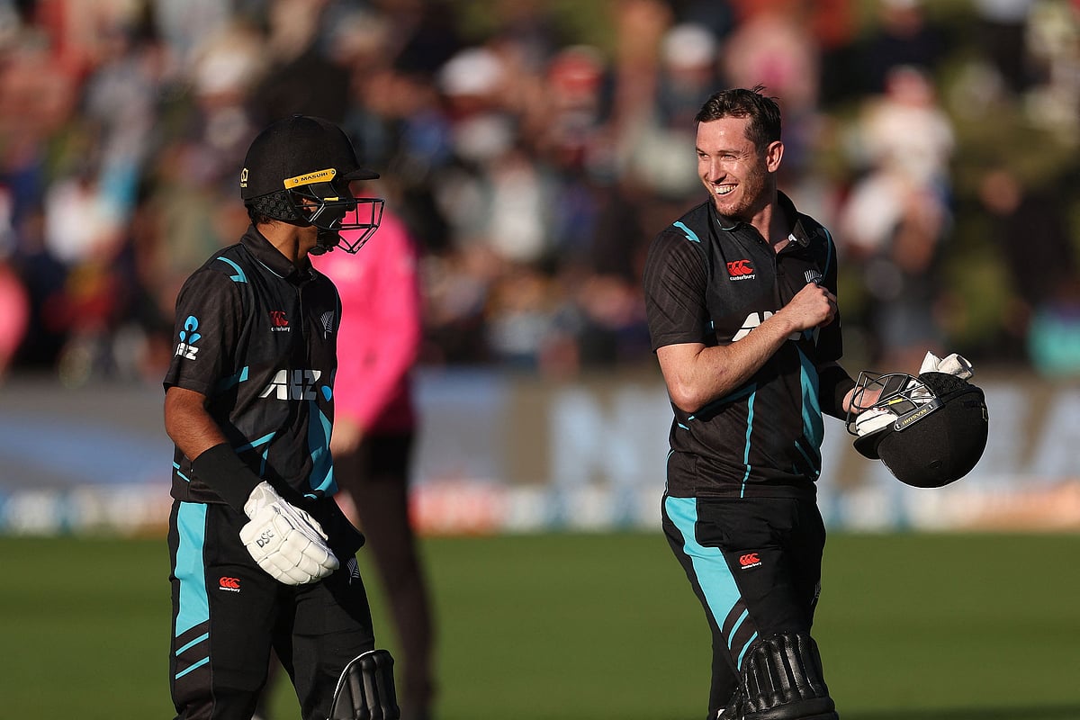 New Zealand's Rachin Ravindra with teammate Adam Milne walk from the field after their series win during the third Twenty20 between New Zealand and Sri Lanka at John Davies Oval in Queenstown on 8 April 2023