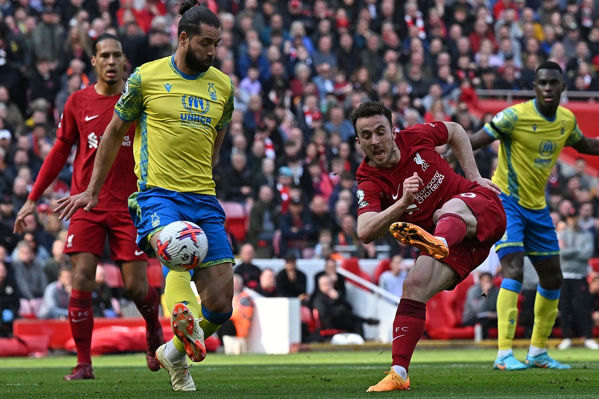 Liverpool's Portuguese striker Diogo Jota shoots to score their second goal during the English Premier League match between Liverpool and Nottingham Forest at Anfield in Liverpool, England on 22 April 2023