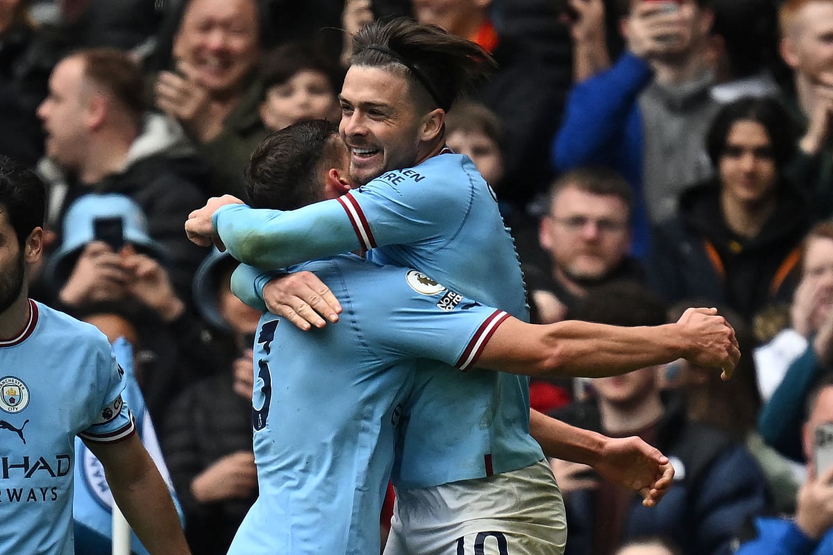 Manchester City's English midfielder Jack Grealish (R) celebrates with teammates after scoring their fourth goal during the English Premier League football match between Manchester City and Liverpool at the Etihad Stadium in Manchester, north west England, on April 1, 2023