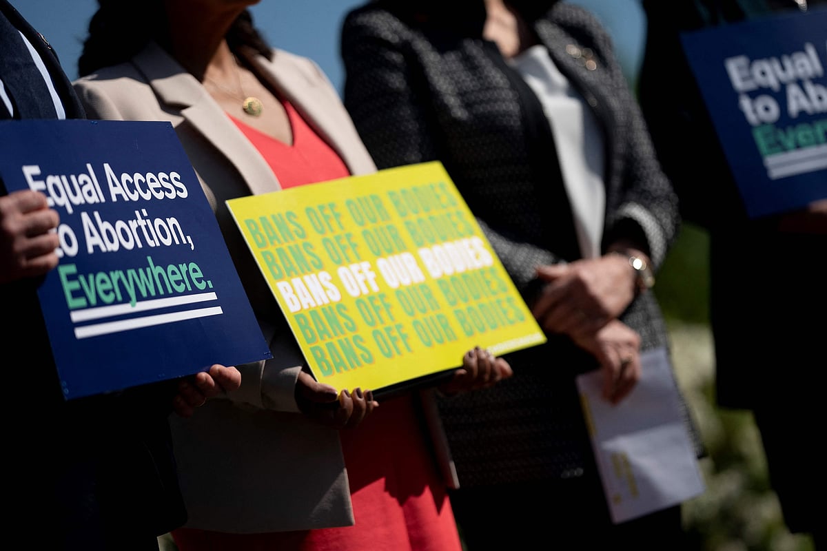 US members of Congress hold signs calling for equal abortion access on Capitol Hill in Washington, DC, on April 19, 2023