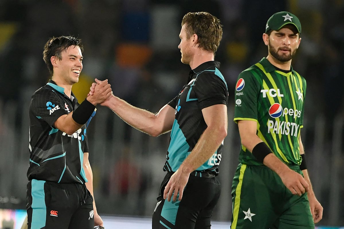 New Zealand's Mark Chapman celebrates with teammate Jimmy Neesham after winning the fifth and final Twenty20 international match between Pakistan and New Zealand at the Rawalpindi Cricket Stadium in Rawalpindi on 25 April 2023