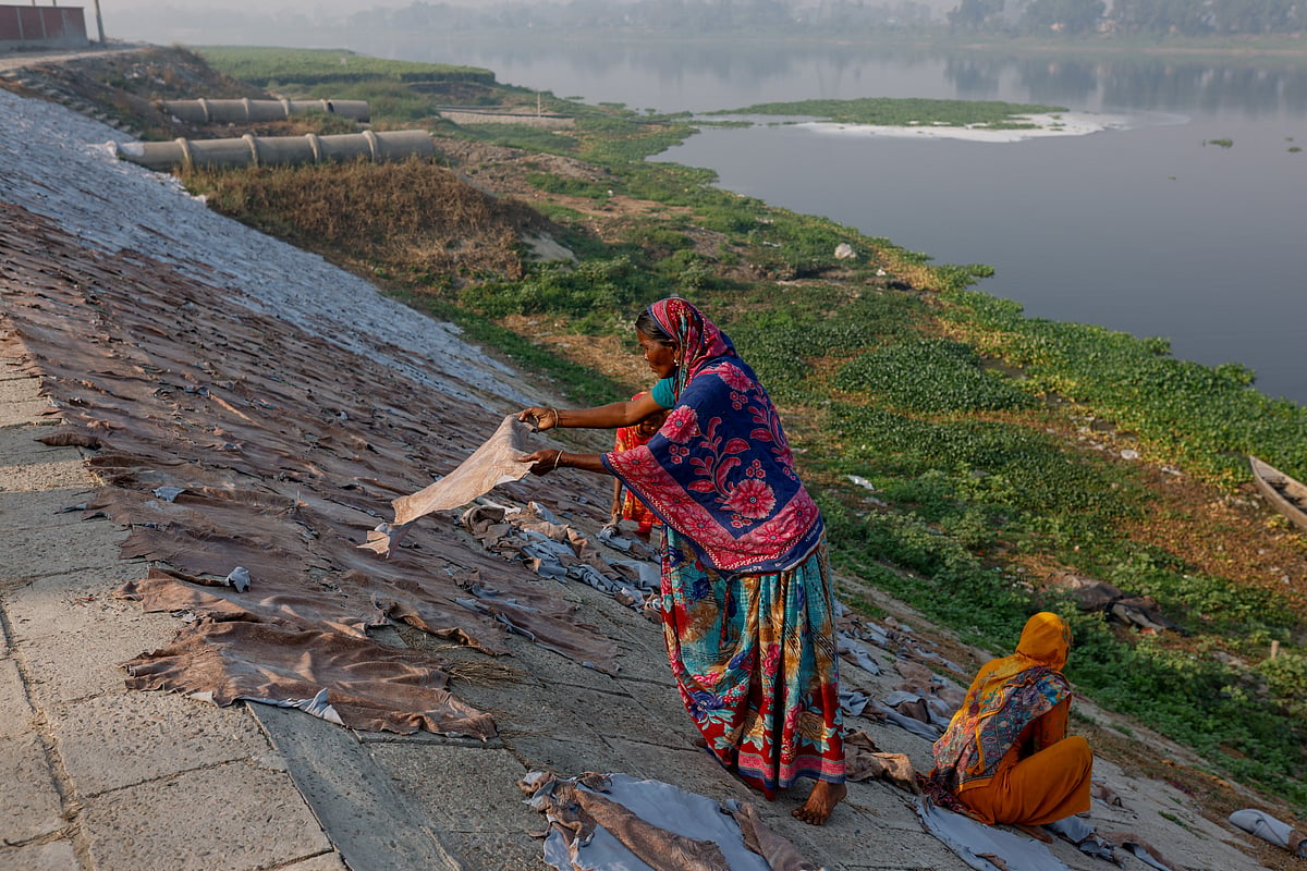 Women dry cattle hides outside a tannery by the Dhaleshwari river, which feeds into the Buriganga river, in Savar, on the outskirts of Dhaka. The Buriganga is so polluted that its water appears pitch black and emits a foul stench.