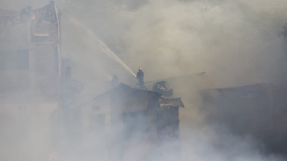 A fire-fighter is working to douse the flame