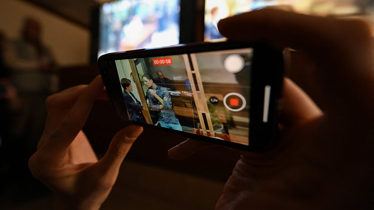 Members of the media gather in front of screens to follow live from a hearing to consider an appeal on the arrest of US journalist Evan Gershkovich, held on espionage charges, at the Moscow City Court in Moscow on 18 April 2023.