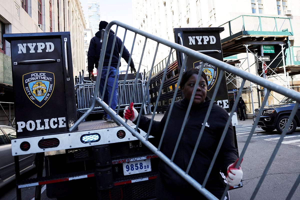 A person holds a barricade outside the Manhattan Criminal Court, after former US President Donald Trump's indictment by a Manhattan grand jury following a probe into hush money paid to porn star Stormy Daniels, in New York City, US, April 2, 2023