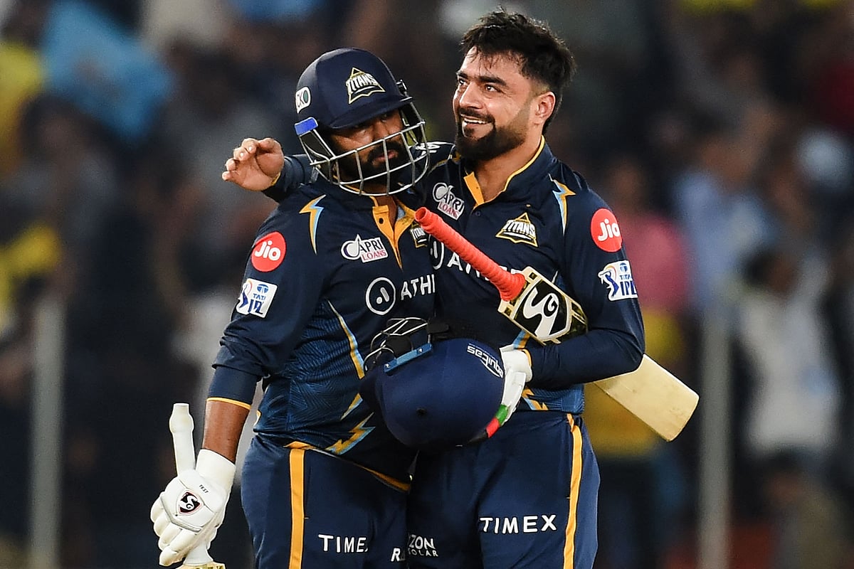 Gujarat Titans' Rahul Tewatia greets teammate Rashid Khan after their win in the Indian Premier League (IPL) match between Gujarat Titans and Chennai Super Kings at the Narendra Modi Stadium in Ahmedabad on 31 March 2023