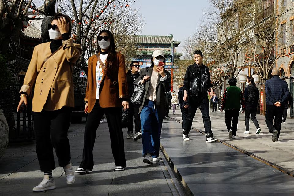 People walk at the tourism site of Qianmen street, in Beijing, China 14 March, 2023.