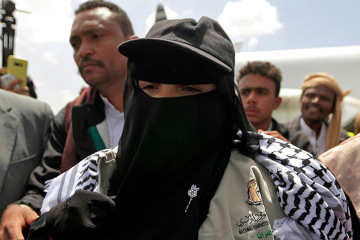 Samira March, whom government forces detained five years ago and accused of organising explosions that killed dozens, gestures upon arrival at Sanaa airport following her release on 17 April, 2023