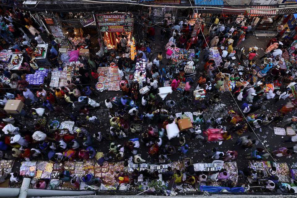 People shop at a crowded market in the old quarters of Delhi, India, on 11 October, 2022.