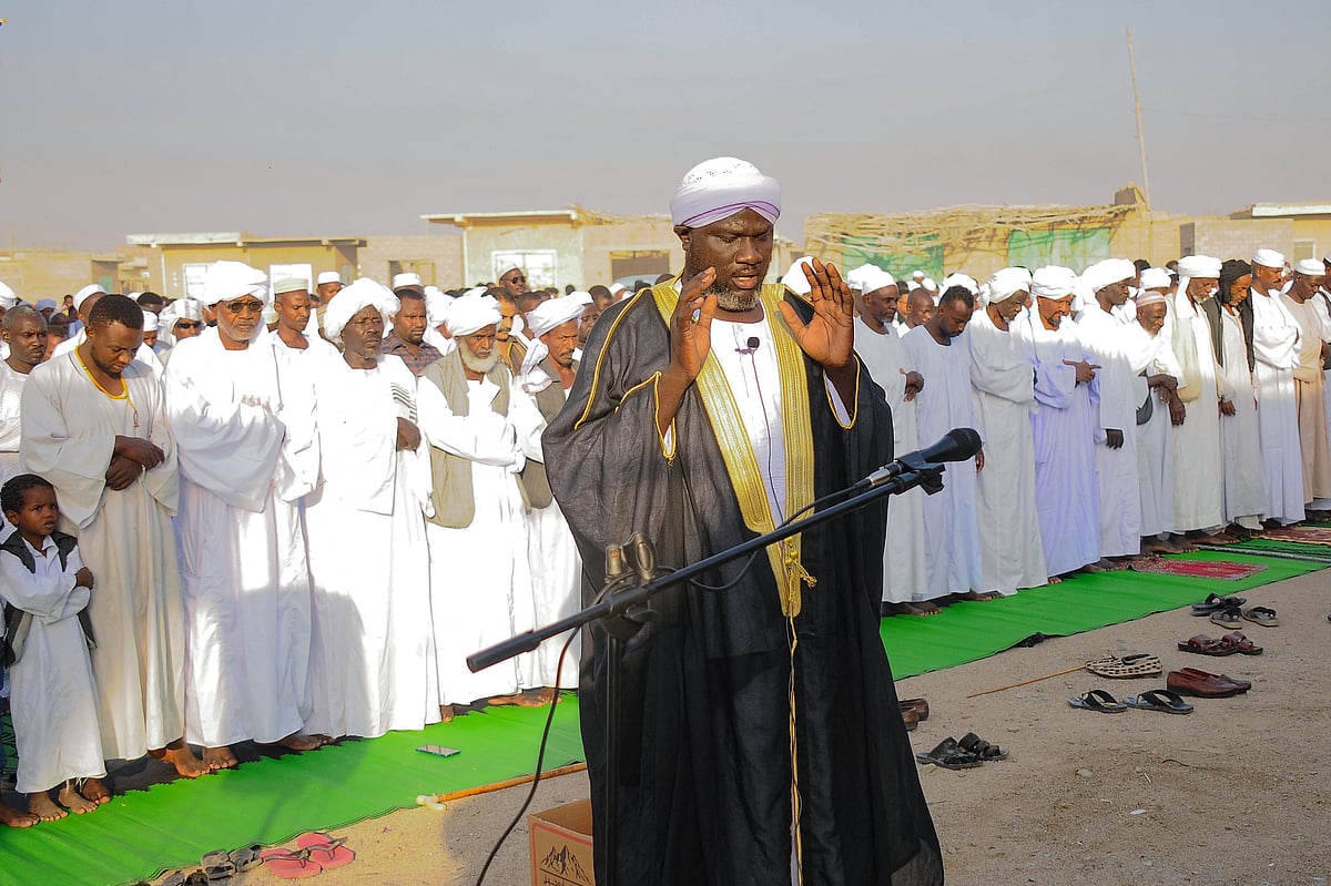 A cleric guides the prayers in Port Sudan, on the first day of Eid al-Fitr, which marks the end of the Muslim fasting month of Ramadan, on April 21, 2023