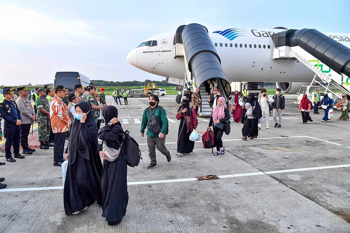 This handout picture taken and released on April 28, 2023 by the Indonesian Foreign Ministry shows the first group of Indonesians evacuated from strife-torn Sudan arriving at Soekarno-Hatta International airport in Jakarta after a chartered flight from Saudi Arabia
