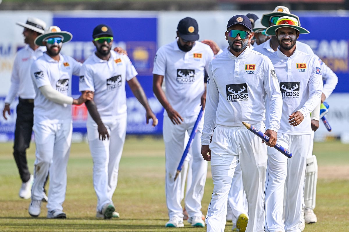 Sri Lanka's captain Dimuth Karunaratne along with teammates walk back to the pavilion after Sri Lanka won by an innings and 280 runs during the third day of the first Test between Sri Lanka and Ireland at the Galle International Cricket Stadium in Galle on 18 April 2023