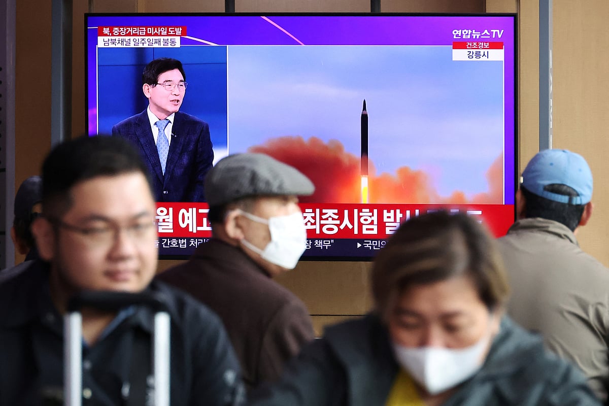 People watch a TV broadcasting a news report on North Korea firing a ballistic missile of intermediate range or longer, at a railway station in Seoul, South Korea, April 13, 2023