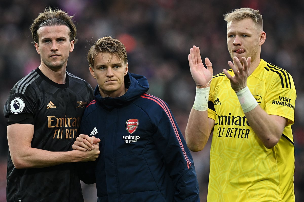 Arsenal's English defender Rob Holding (L), Arsenal's Norwegian midfielder Martin Odegaard (C) and Arsenal's English goalkeeper Aaron Ramsdale applaud the fans following during the English Premier League football match between Liverpool and Arsenal at Anfield in Liverpool, north west England on April 9, 2023
